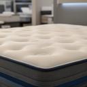 Memory foam mattress with smooth quilted top in a modern bedroom showroom setting